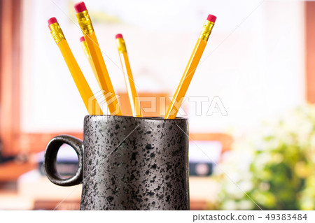 Yellow simple pencil with books on window 49383484