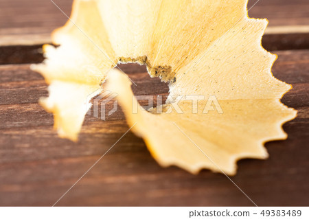 Yellow simple pencil on brown wood 49383489