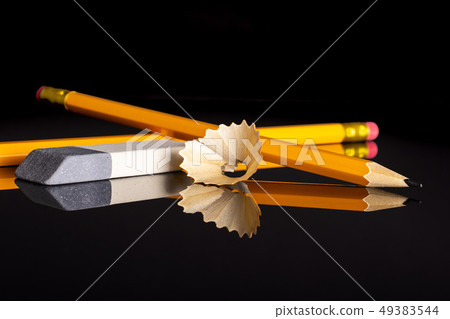 Yellow simple pencil isolated on black glass Yellow simple pencil isolated on black glass 49383544