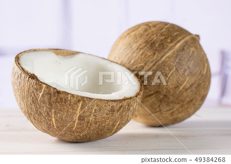 Fresh bio coconut with red tulips Fresh bio coconut with red tulips 49384268