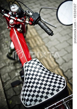 Red bike on the sidewalk Red bike on the sidewalk 49384387