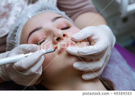 Permanent Makeup For Eyebrows. Microblading brow. Beautician Doing Eyebrow Tattooing For Female Face Permanent Makeup For Eyebrows. Microblading brow. Beautician Doing Eyebrow Tattooing For Female Face 49384583