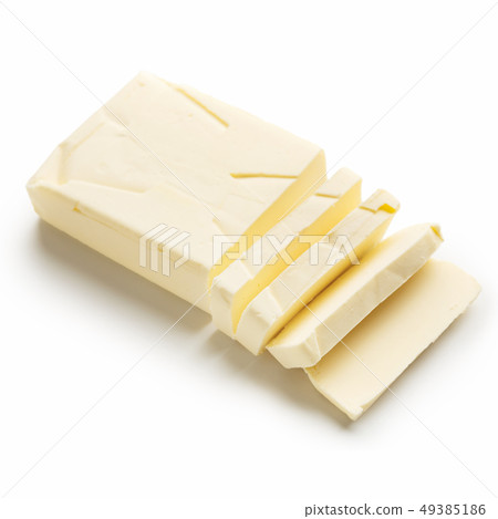 Piece of sliced butter on white 49385186