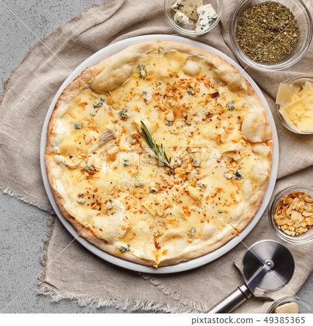 Pizza quattro fromaggi decorated with chopped nuts closeup Pizza quattro fromaggi decorated with chopped nuts closeup 49385365