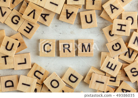 Top down view, pile of square wooden blocks with letters CRM stands for Customer Relationship Top down view, pile of square wooden blocks with letters CRM stands for Customer Relationship 49386035