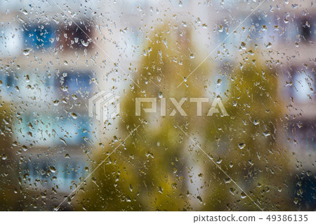 rain outside the window, drops of rain on the windowpane rain outside the window, drops of rain on the windowpane 49386135