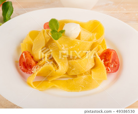 Yellow italian pasta pappardelle, fettuccine or 49386530