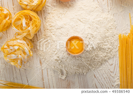 Raw yellow italian pasta pappardelle, fettuccine 49386540