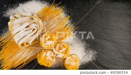 Raw yellow italian pasta pappardelle, fettuccine 49386554