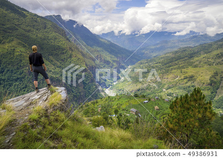 Man standing on hill top in Himalayas 49386931