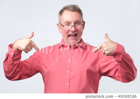 Senior man in red shirt and glasses is proud Senior man in red shirt and glasses is proud 49388186
