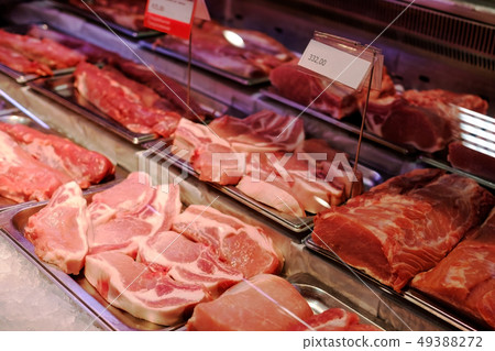 Sliced raw meat on a shelf in a supermarket. 49388272