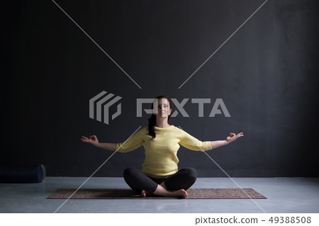 Young woman practicing yoga, sitting on meditation Young woman practicing yoga, sitting on meditation 49388508