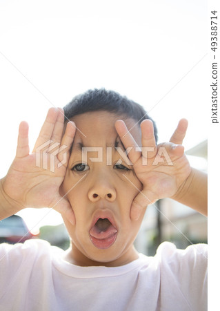 close up face of asian children showing milk tooth 49388714