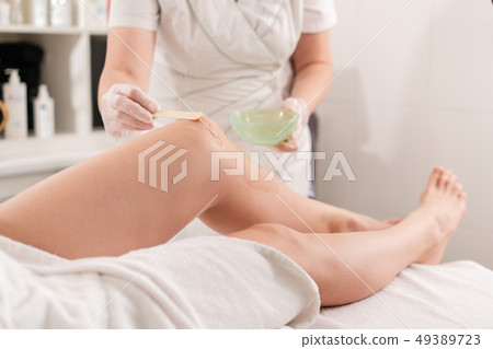 Laser epilation and cosmetology. Hair removal on ladies legs. at cosmetic beauty spa clinic Laser epilation and cosmetology. Hair removal on ladies legs. at cosmetic beauty spa clinic 49389723