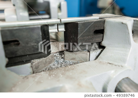 vise to secure the workpiece. Circular saw machine. Cutting a metal and steel with with sharp vise to secure the workpiece. Circular saw machine. Cutting a metal and steel with with sharp 49389746