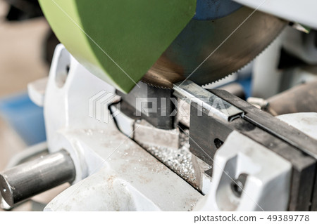 Circular saw machine. Cutting a metal and steel with with sharp, circular blade in workshop interior 49389778