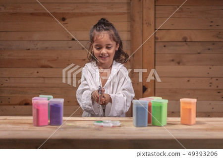 a long hair boy playing colors in wooden room a long hair boy playing colors in wooden room 49393206