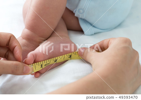 Measuring the size of the foot baby, Infant body 49393470