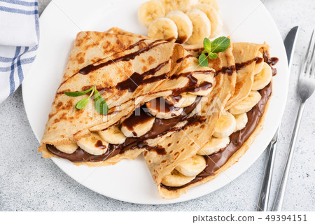 Crepes or blini stuffed with chocolate, banana 49394151