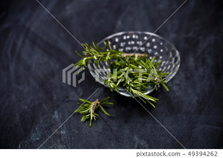 Fresh rosemary herb in glass bowl. Fresh rosemary herb in glass bowl. 49394262