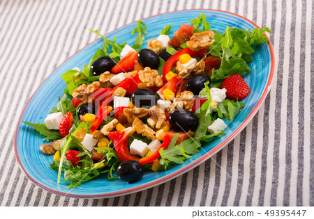 Salad of arugula with tomatoes, pepper, feta cheese, strawberry 49395447