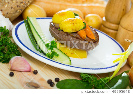 Beef rissole with baked new potatoes, carrots 49395648