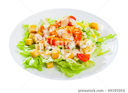 Caesar salad with grilled chicken on a white plate Caesar salad with grilled chicken on a white plate 49395958