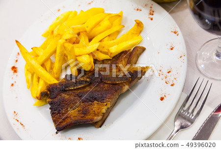 Pork ribs barbecue served with French fries Pork ribs barbecue served with French fries 49396020