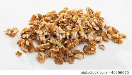 Pile of shelled walnuts on white surface 49396070