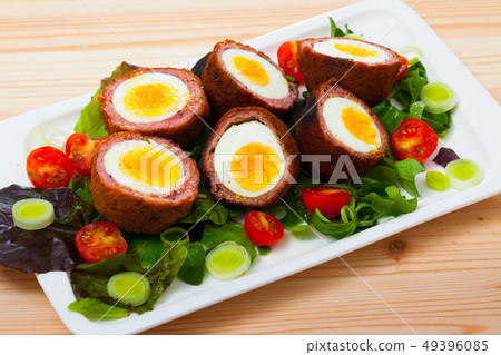 Scotch eggs with vegetables and greens 49396085