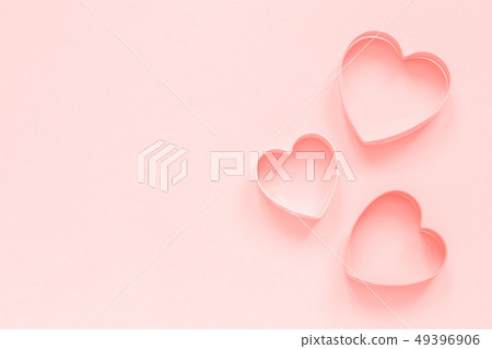 Pink cutters cookies in heart shape on pastel pink 49396906