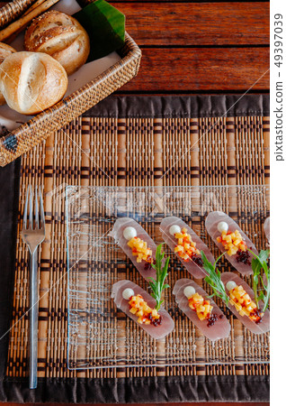 Fresh snapper Tataki with mango salsa and arugulas 49397039