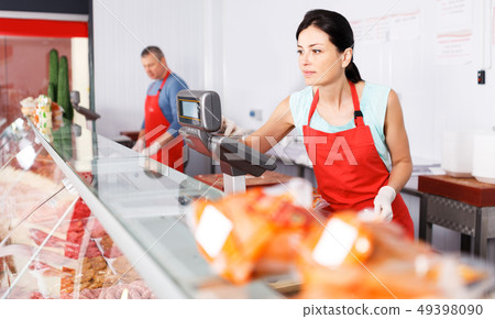 woman seller working at meat market 49398090