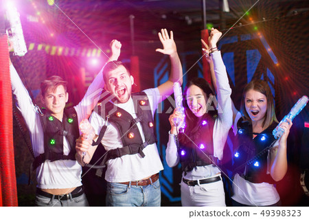 Friends with laser guns in colored beams 49398323