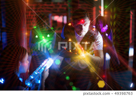 Excited guy laser tag player in bright beams Excited guy laser tag player in bright beams 49398763