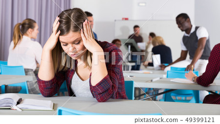Unhappy girl student in class Unhappy girl student in class 49399121