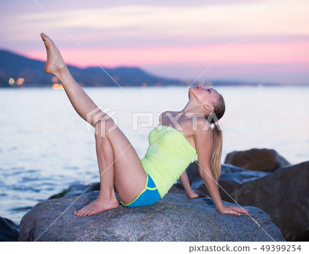 Beautiful sporty female doing aerobics 49399254