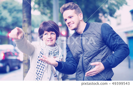 Adult male tourist asks for directions Adult male tourist asks for directions 49399543