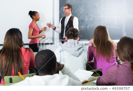 Man giving a math lesson 49399707