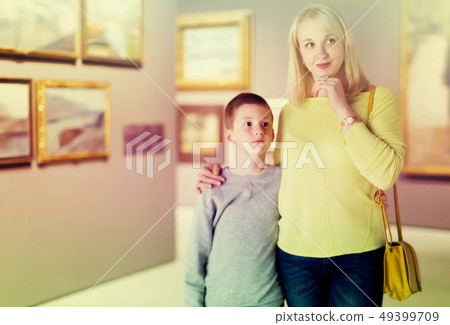 Cheerful mom and son exploring paintings 49399709