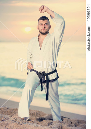 Guy doing karate poses Guy doing karate poses 49399804