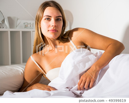 Woman in lingerie lying in bed Woman in lingerie lying in bed 49399819