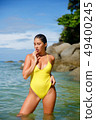 Beautiful girl posing on the beach in the hot sun 49400245