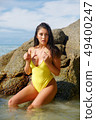 Beautiful girl posing on the beach in the hot sun 49400247