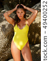 Beautiful girl posing on the beach in the hot sun 49400252