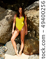 Beautiful girl posing on the beach in the hot sun 49400256
