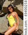 Beautiful girl posing on the beach in the hot sun 49400258