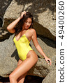 Beautiful girl posing on the beach in the hot sun 49400260