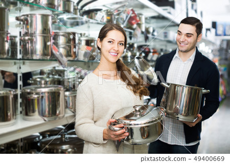 couple chooses pans in shop cookware couple chooses pans in shop cookware 49400669